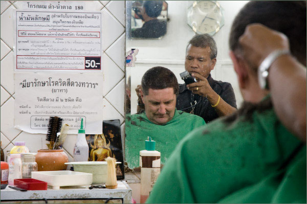Photograph of Stilgherrian having a haircut in Bangkok