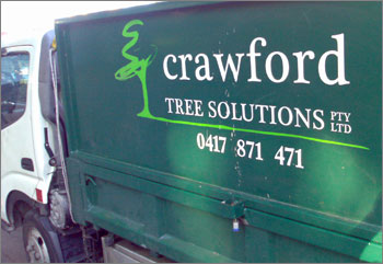 Photograph of truck with sign on side: Crawford Tree Solutions Pty Ltd 0417 871 471