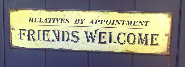 Photograph of sign on gate: Relatives by appointment, friends welcome