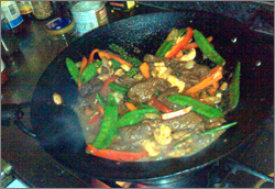Photographs of kangaroo red curry stir-fry being prepared in a wok and served on a plate