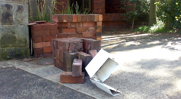 Photograph of our broken brick fence and letterbox