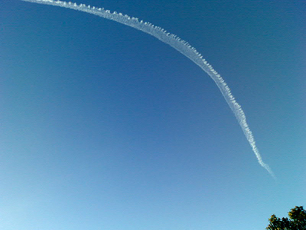 Photo of a jet contrail in a clear blue sky