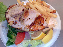 Photograph of Swordfish steak with chips and salad